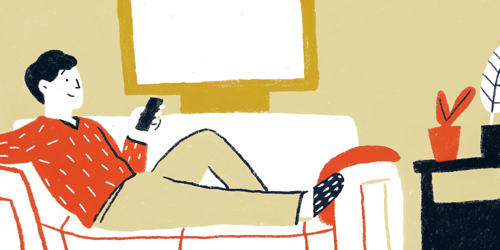 man uses a phone while sitting on the couch